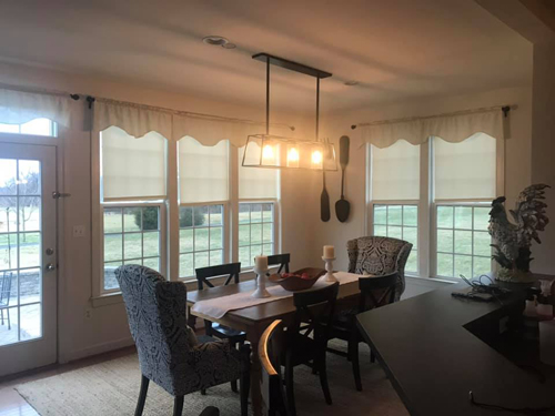 Pendant lighting above a dining table in a bright breakfast room