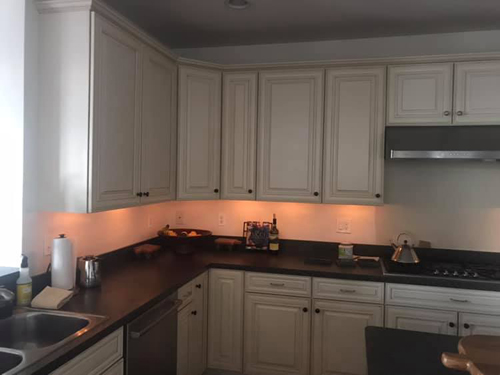 Kitchen counters illuminated by under-cabinet lights